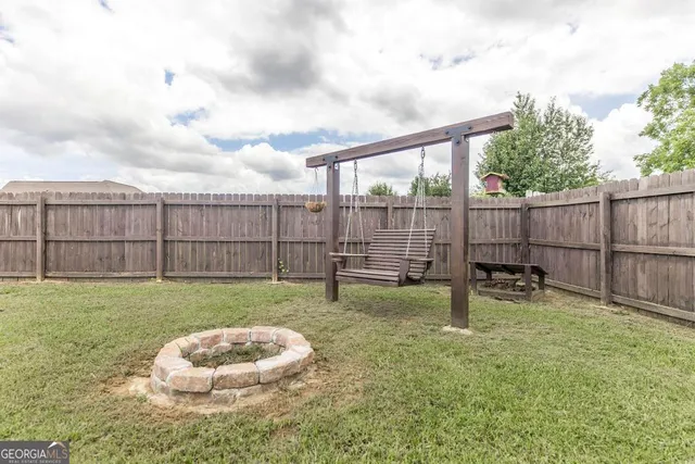 a backyard of a house with table and chairs