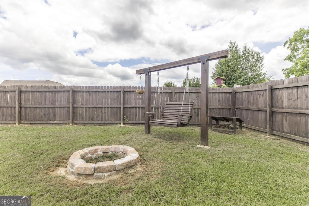 113 Flat Rock Lane Perry, GA 31069 - Photo 38 of 39 a backyard of a house with table and chairs