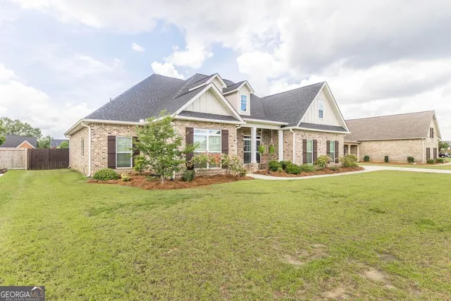 a front view of a house with swimming pool having outdoor seating