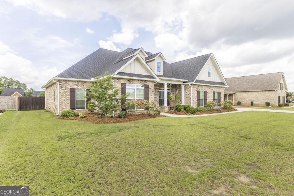 113 Flat Rock Lane Perry, GA 31069 - Photo 4 of 39 a front view of a house with swimming pool having outdoor seating