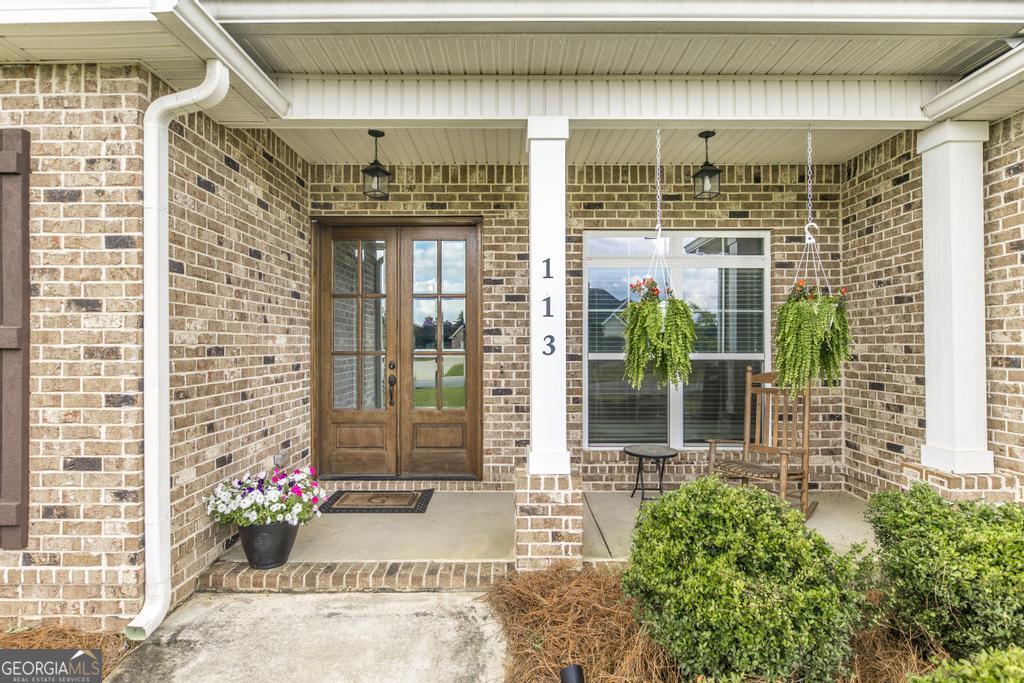 113 Flat Rock Lane Perry, GA 31069 - Photo 6 of 39 a view of a entryway door front of house