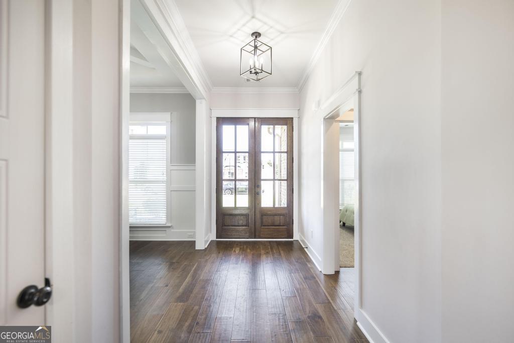113 Flat Rock Lane Perry, GA 31069 - Photo 7 of 39 an empty room with wooden floor and windows