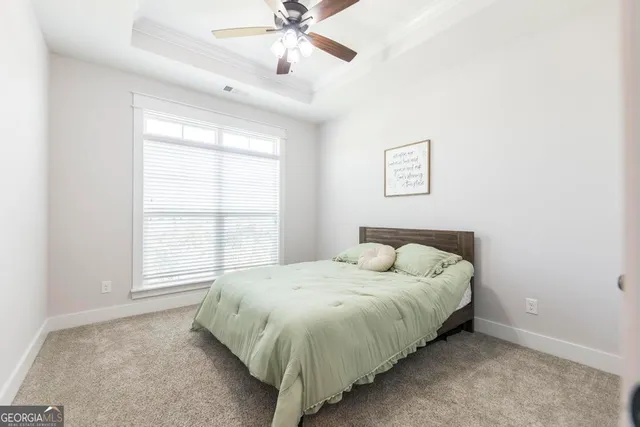 a bed sitting in a bedroom next to a window
