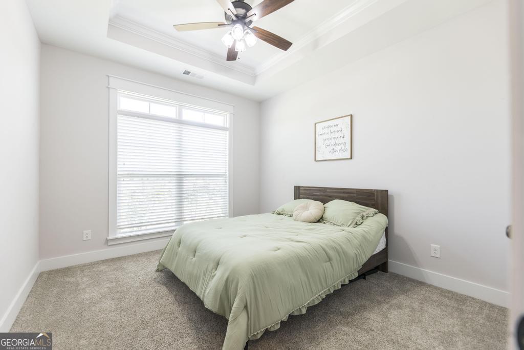 113 Flat Rock Lane Perry, GA 31069 - Photo 10 of 39 a bed sitting in a bedroom next to a window