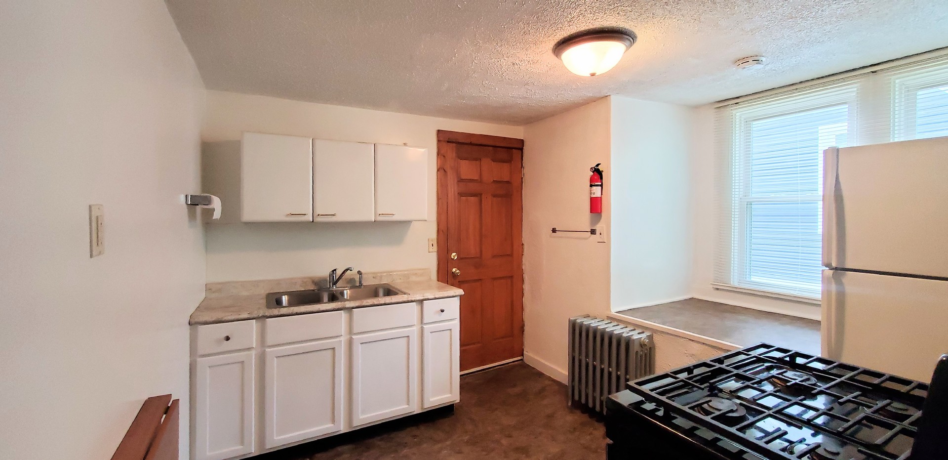 414 Oneida Street, Unit 1UPPER Joliet, IL 60435 - Photo 3 of 9 a kitchen with stainless steel appliances a refrigerator sink and cabinets