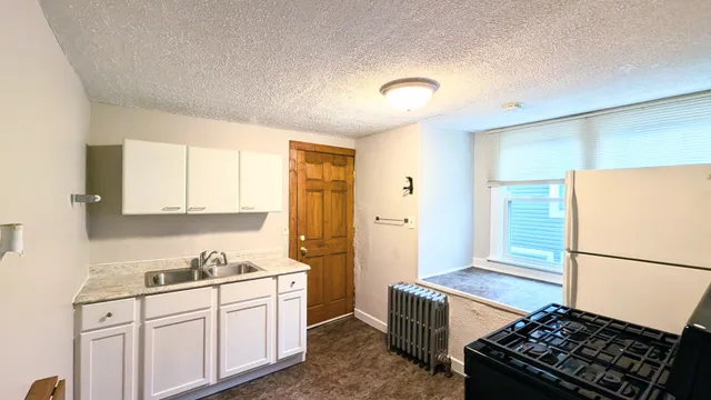 a kitchen with a sink stove and refrigerator