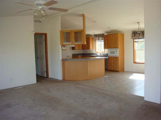 5731 State Highway 99w Corning, CA 96021 - Photo 3 of 6 a kitchen with stainless steel appliances granite countertop a refrigerator a sink dishwasher a stove top oven a sink and dishwasher