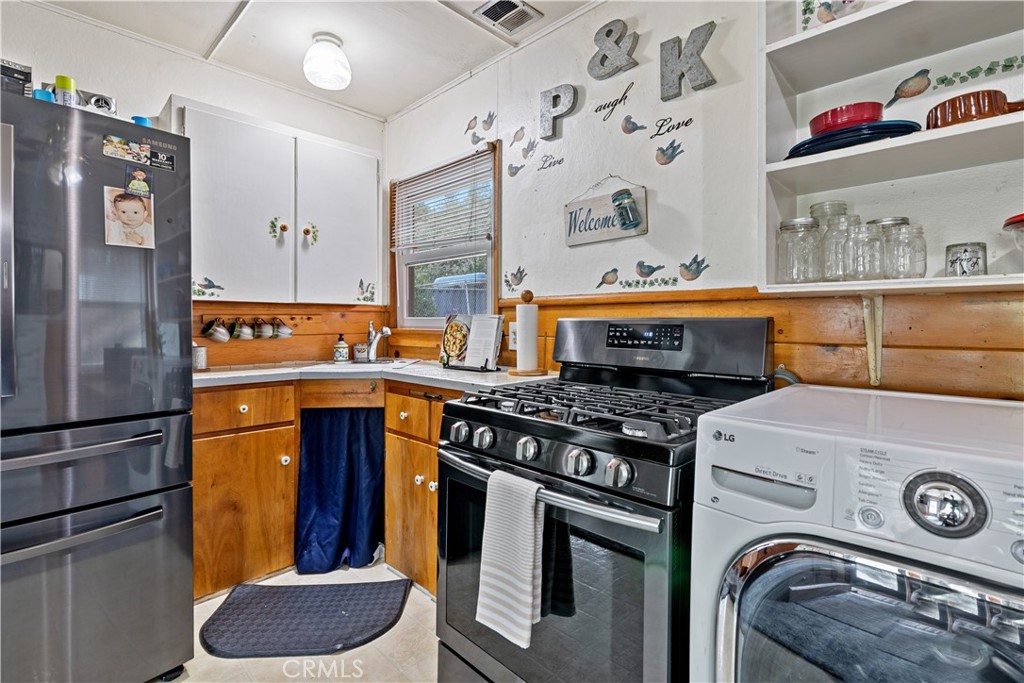 23526 Knapps Cutoff Crestline, CA 92325 - Photo 13 of 30 a kitchen with stainless steel appliances granite countertop a stove and a refrigerator