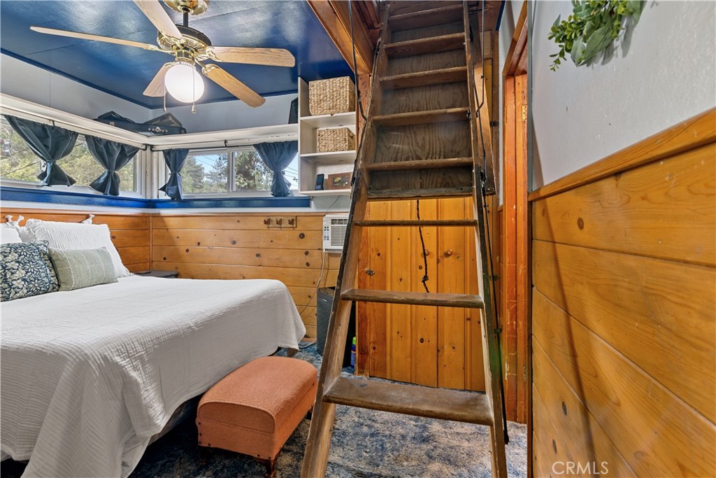 23526 Knapps Cutoff Crestline, CA 92325 - Photo 20 of 30 a bedroom with a bed and wooden floor