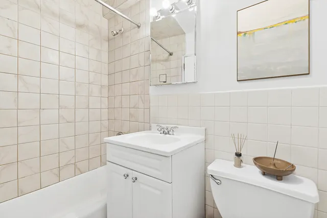 a bathroom with a sink toilet and a mirror