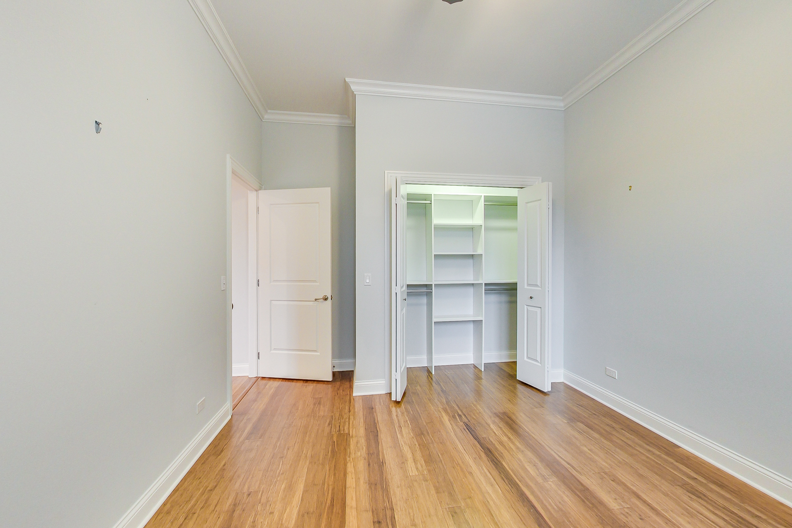1247 West Madison Street, Unit 212 Chicago, IL 60607 - Photo 10 of 12 a view of empty room with wooden floor