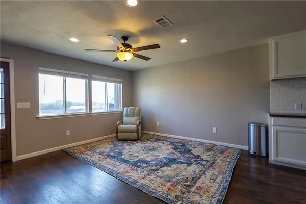 a view of a livingroom with furniture and a ceiling fan