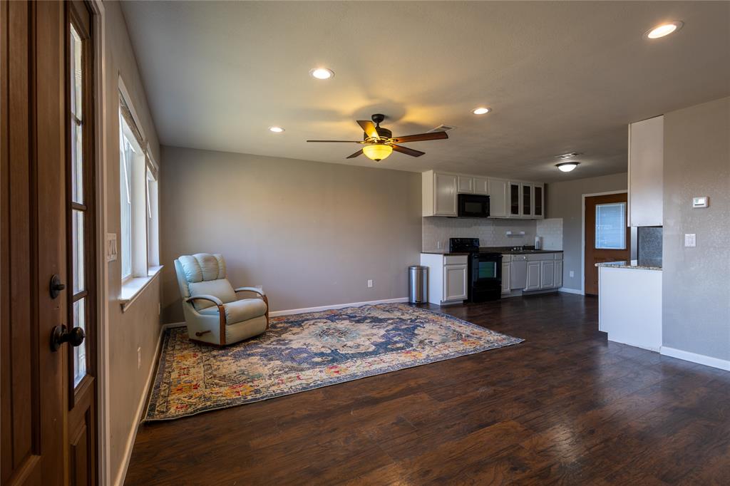 5780 Randle Road Granbury, TX 76049 - Photo 4 of 16 a living room with kitchen view and a wooden floor