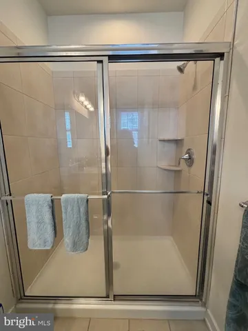 a view of walk in closet with clothes