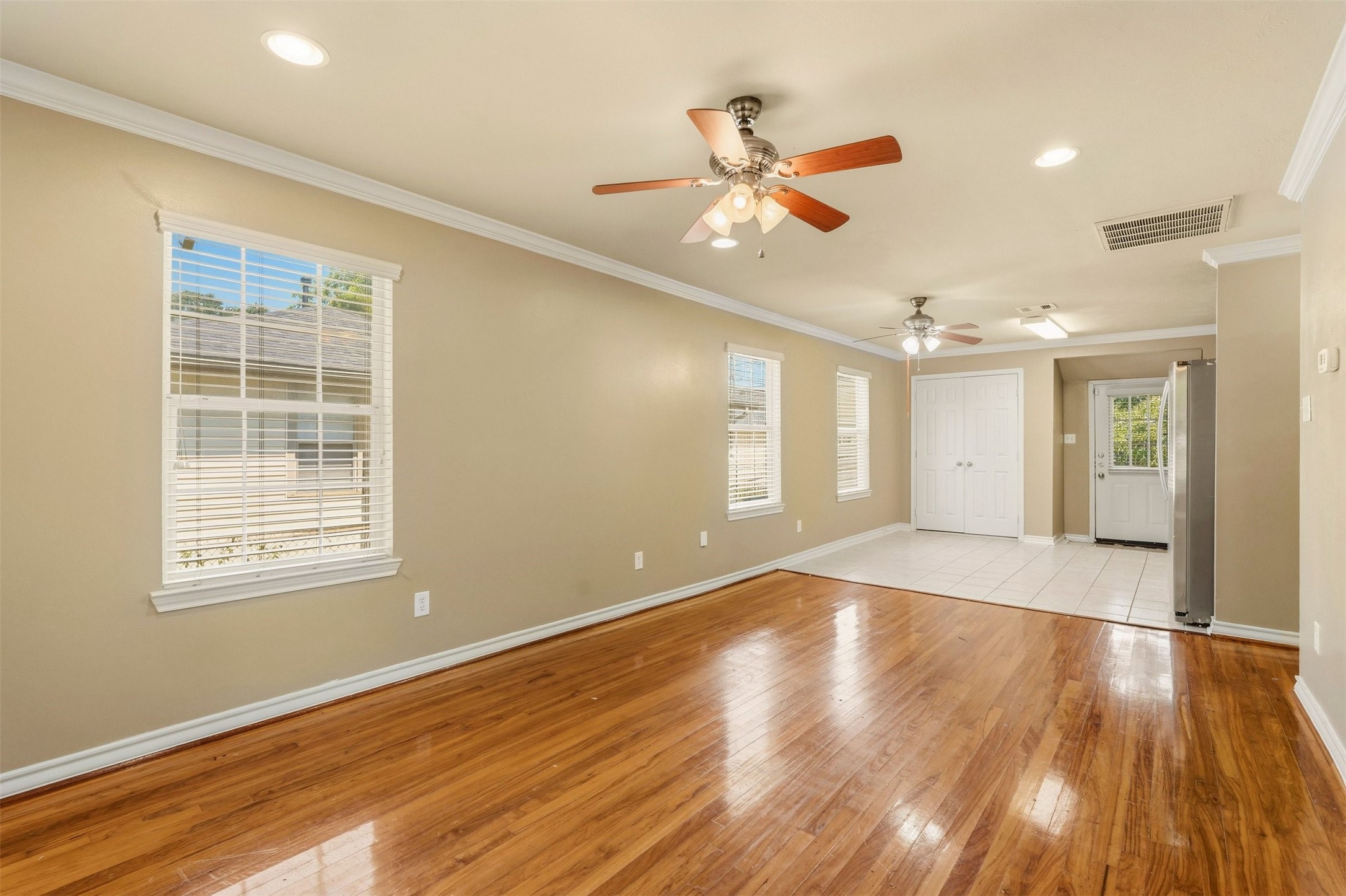 3445 Nathaniel Brown Street Houston, TX 77021 - Photo 3 of 19 a view of an empty room with wooden floor and a window