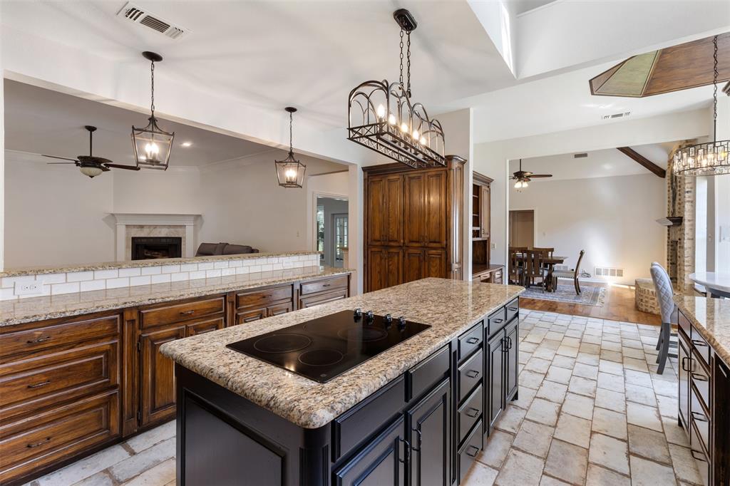609 Seville Road Denton, TX 76205 - Photo 4 of 40 Huge center island with electric cooktop, plus long breakfast bar.