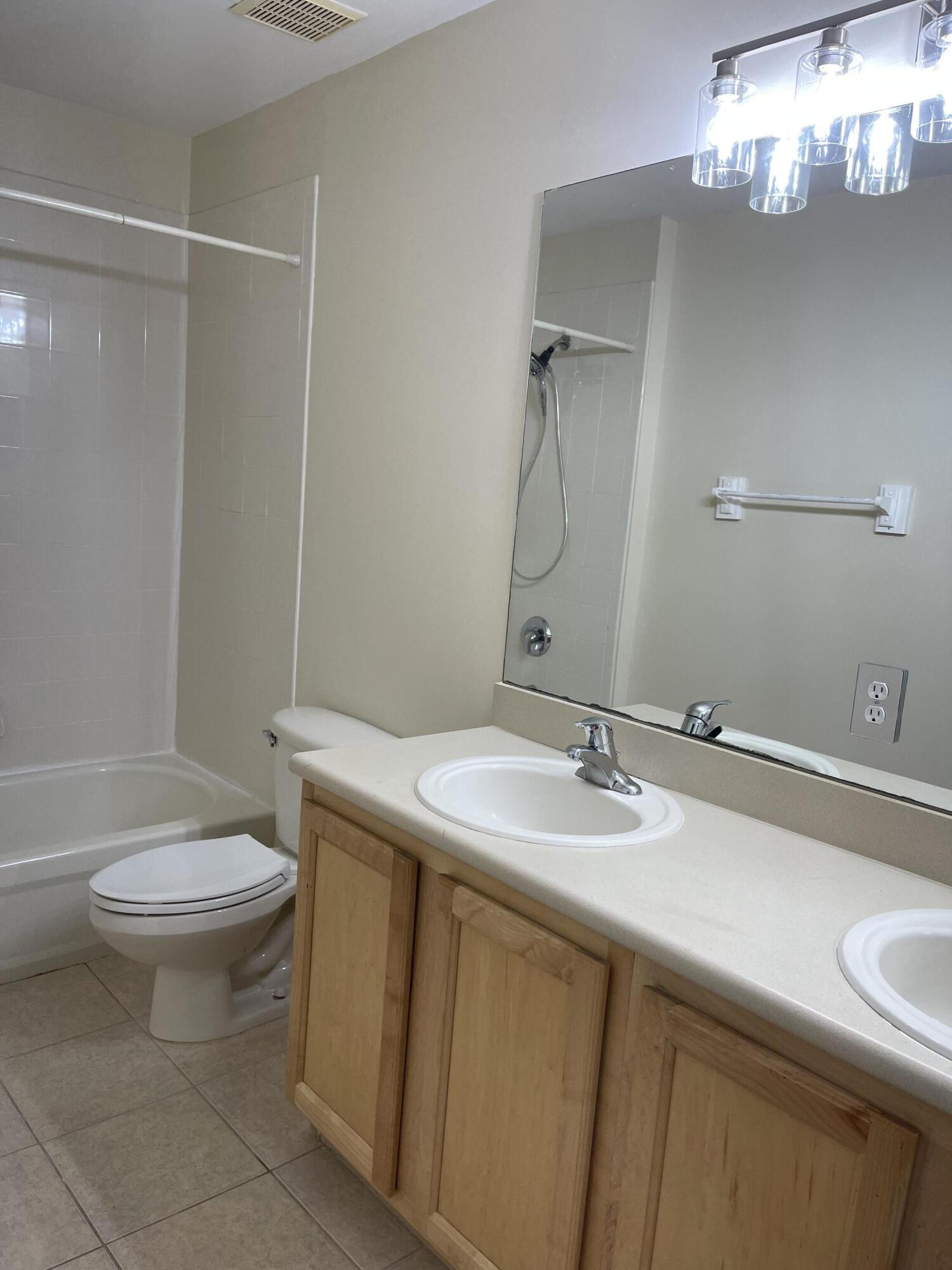 1146 Imperial Lake Road Lake Belvedere Estates, FL 33413 - Photo 13 of 20 a bathroom with a sink a toilet and shower