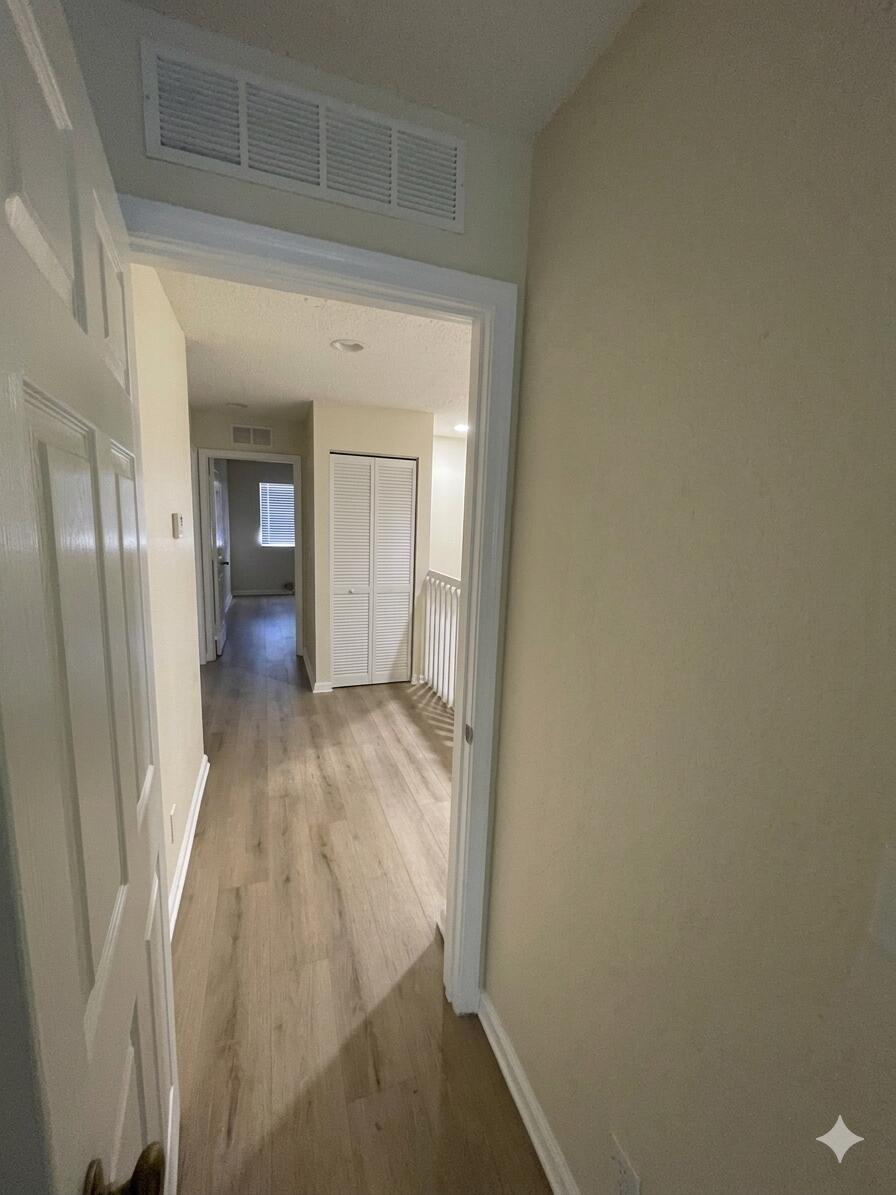 1146 Imperial Lake Road Lake Belvedere Estates, FL 33413 - Photo 14 of 20 view of hallway with wooden floor
