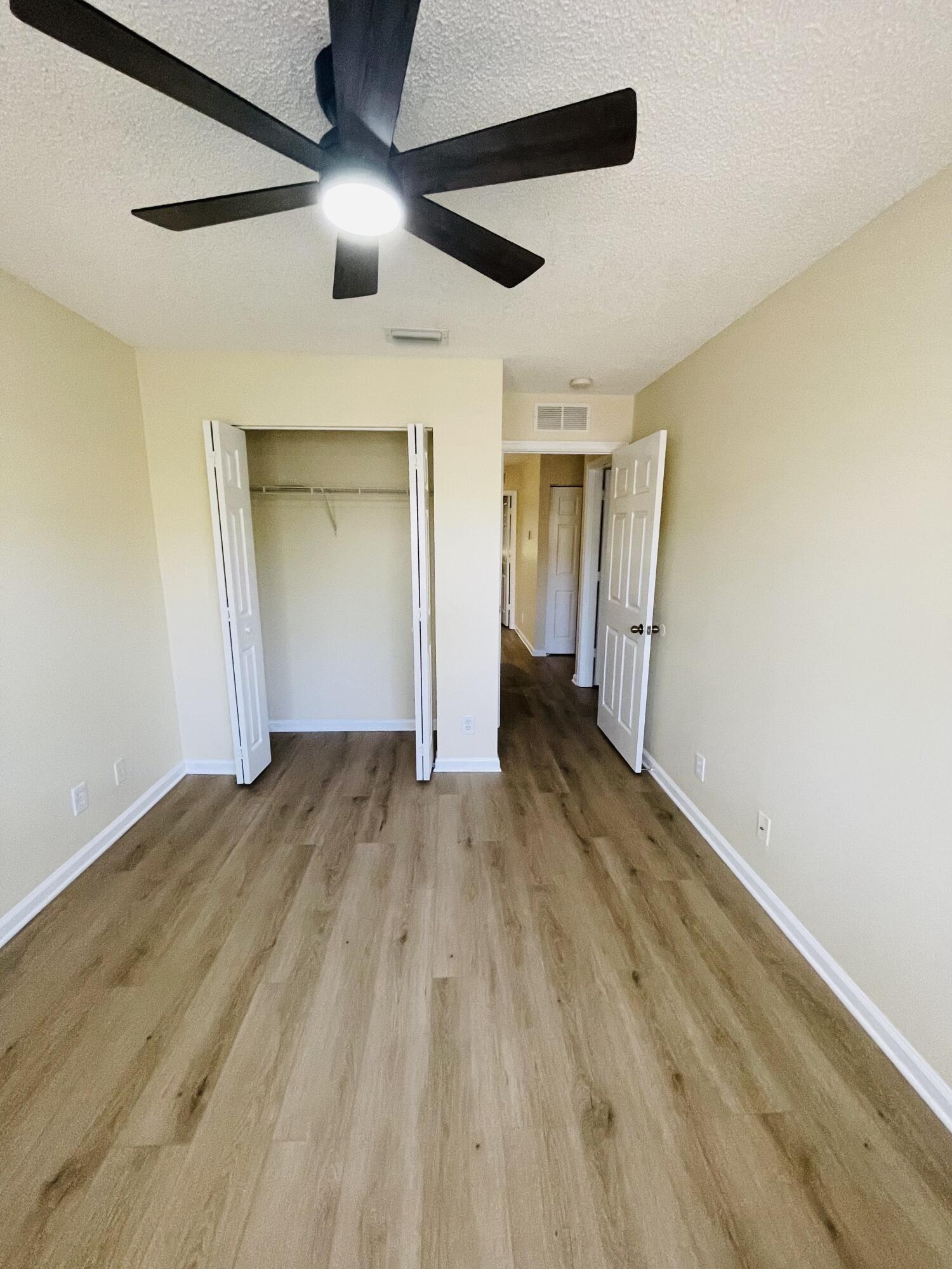 1146 Imperial Lake Road Lake Belvedere Estates, FL 33413 - Photo 17 of 20 a view of empty room with wooden floor