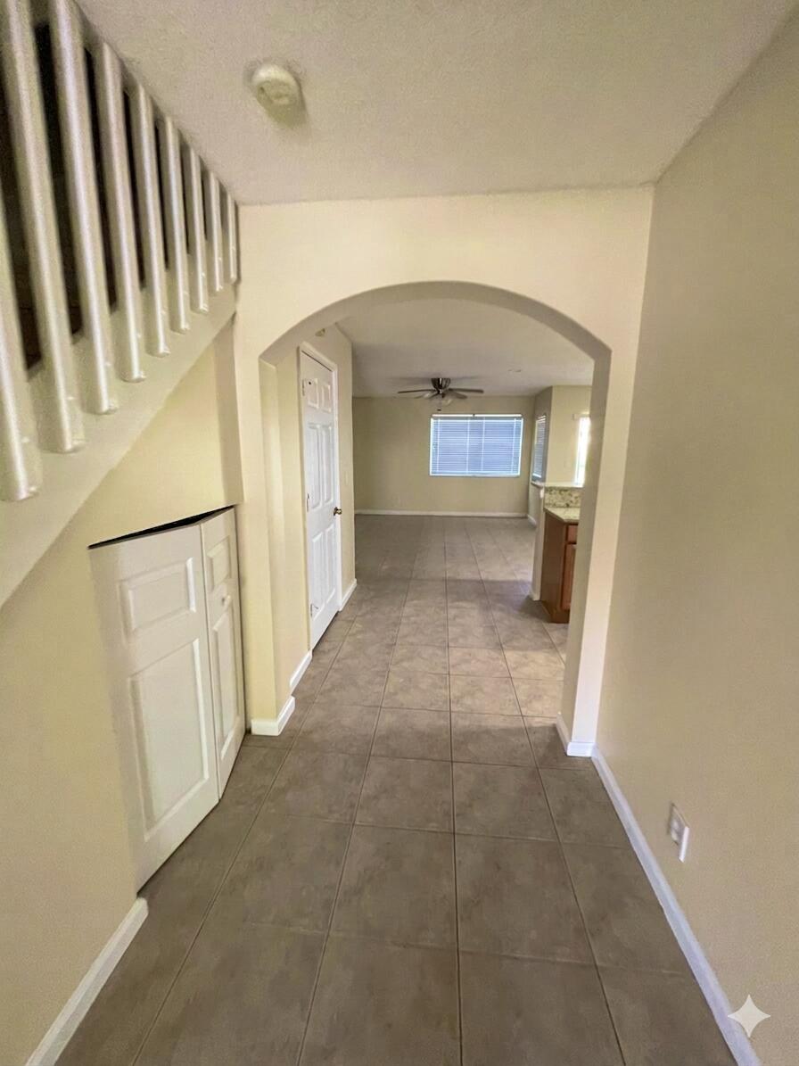 1146 Imperial Lake Road Lake Belvedere Estates, FL 33413 - Photo 3 of 20 a view of a hallway view with wooden floor and staircase