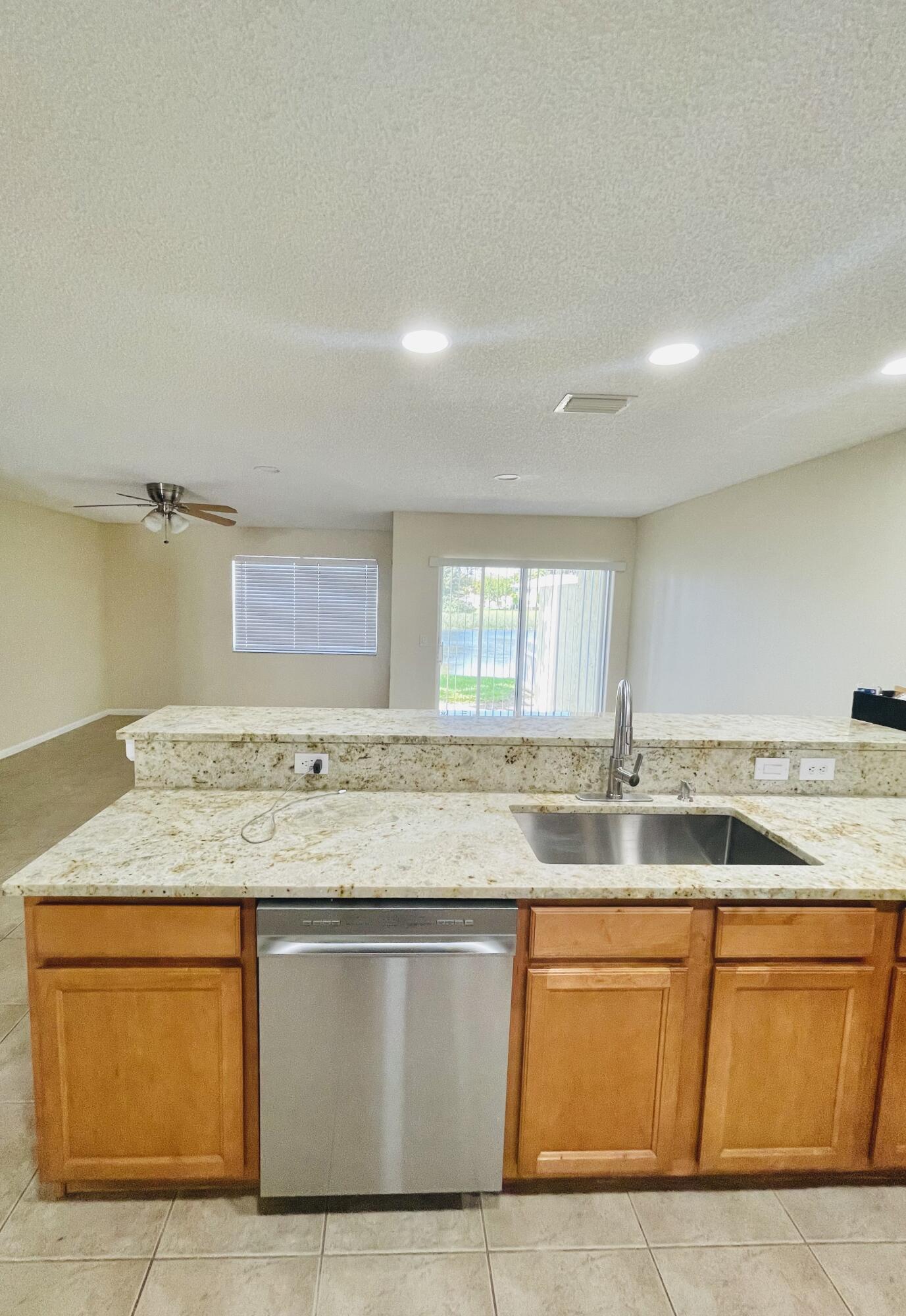 1146 Imperial Lake Road Lake Belvedere Estates, FL 33413 - Photo 7 of 20 a view of kitchen with granite countertop sink and stove