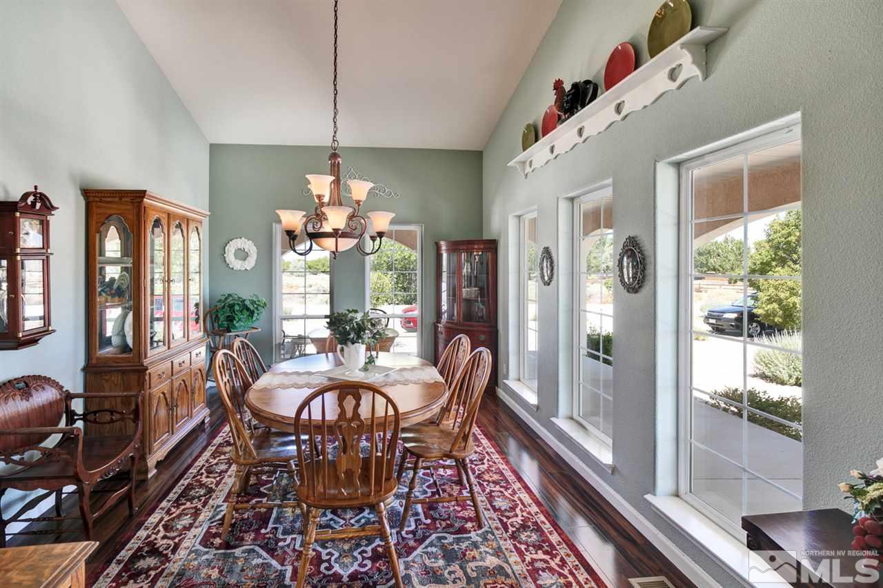 4111 Rancheria Road Fallon, NV 89406 - Photo 12 of 40 a dining room with furniture a chandelier and wooden floor