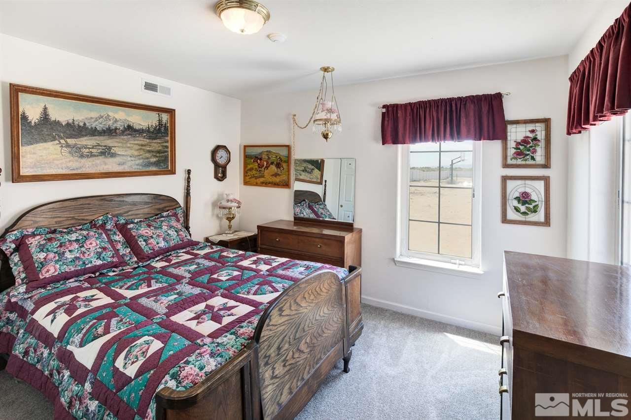 4111 Rancheria Road Fallon, NV 89406 - Photo 31 of 40 a bedroom with a bed a dresser and next to a window