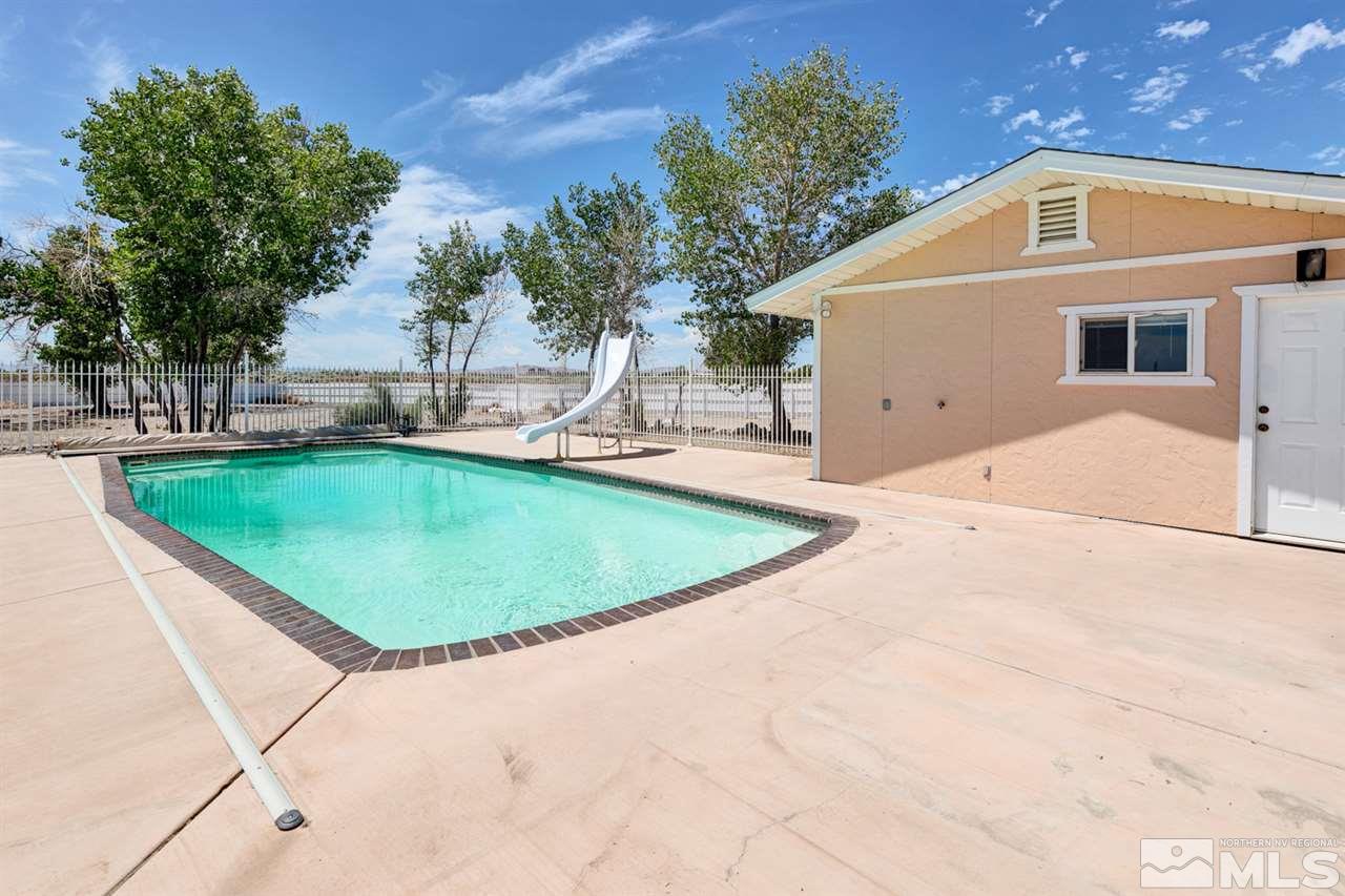 4111 Rancheria Road Fallon, NV 89406 - Photo 39 of 40 a view of a house with a swimming pool and sitting area