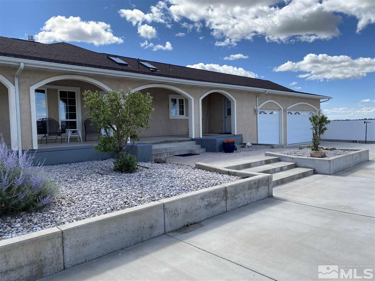 4111 Rancheria Road Fallon, NV 89406 - Photo 7 of 40 a front view of a house with lots of potted plants