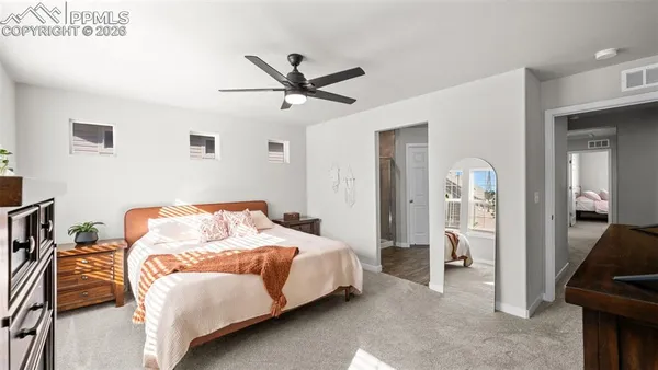 a bedroom with a bed and a mirror