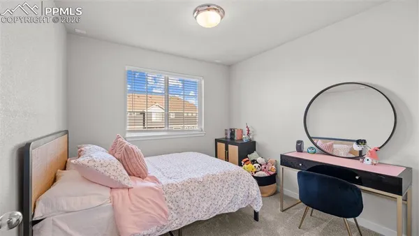 a bedroom with a bed a mirror and a window