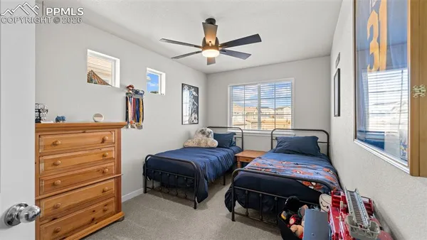 a bedroom with two beds and a window