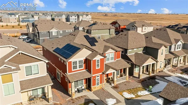 an aerial view of multiple houses with a yard