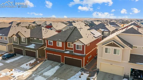 an aerial view of a house with a big yard