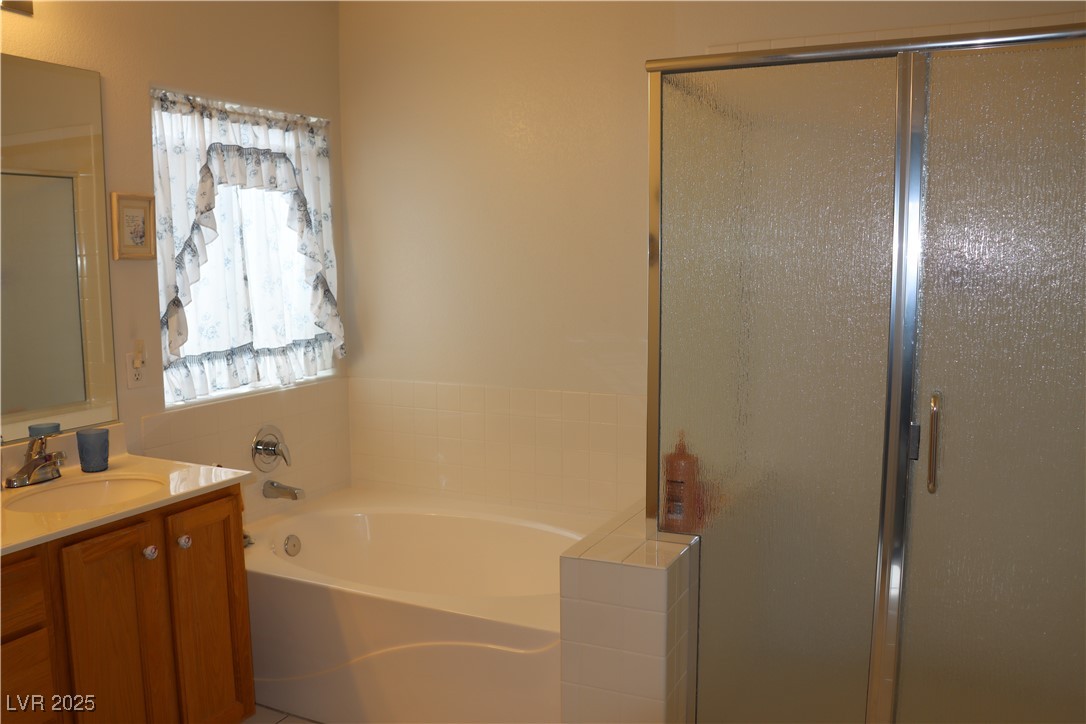 2148 Hidden Ranch Terrace Henderson, NV 89052 - Photo 18 of 31 Full bath with a stall shower, vanity, and a garden tub