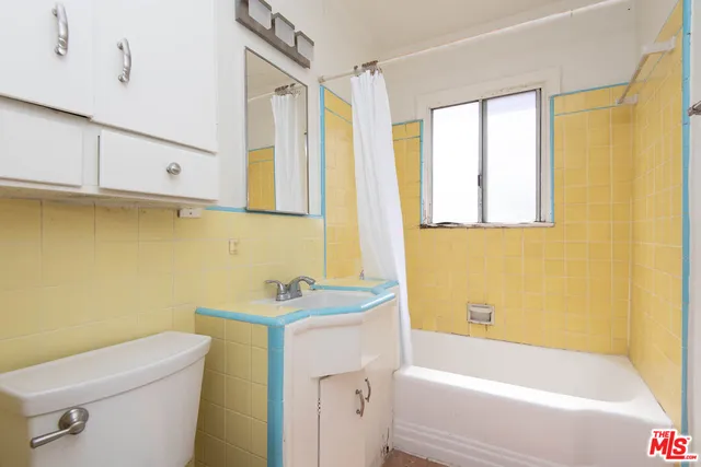 a bathroom with a sink a toilet and a bathtub