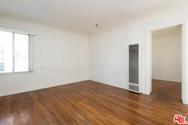 an empty room with wooden floor