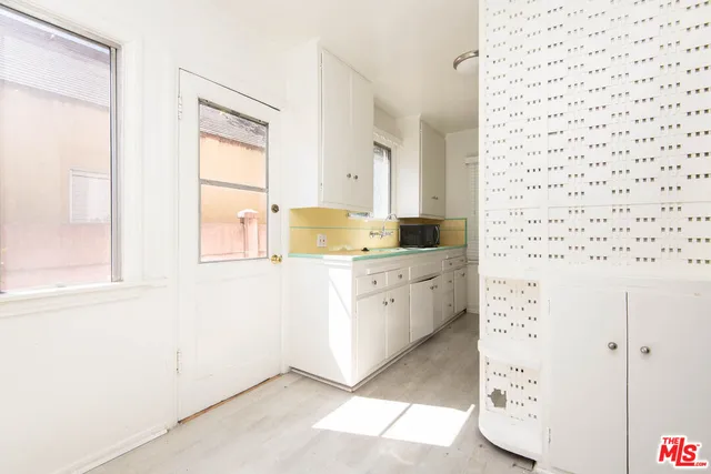 a room with a cabinets and a window