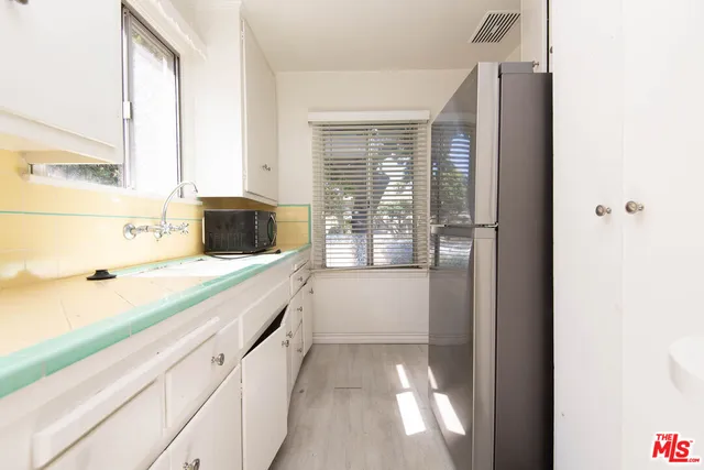 a bathroom with a granite countertop sink a vanity and a large mirror