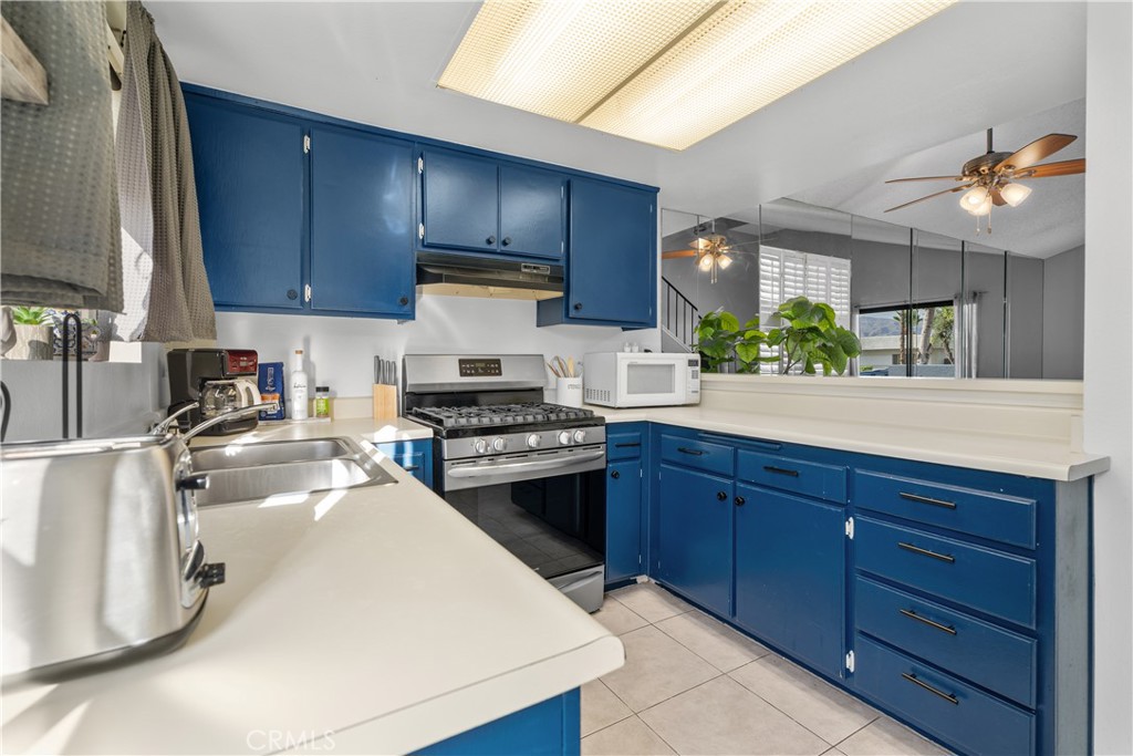 69646 Antonia Way Rancho Mirage, CA 92270 - Photo 27 of 50 a kitchen with a sink a stove and cabinets