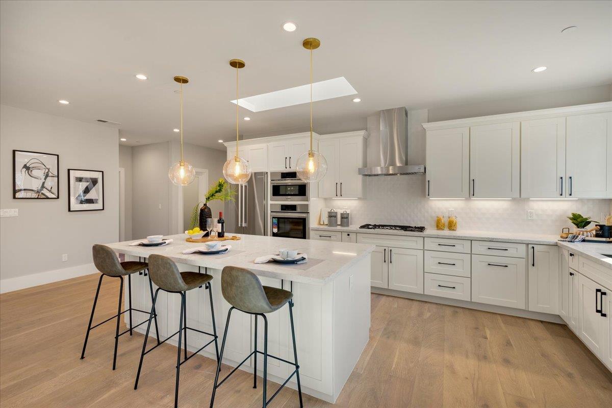 1472 South Wolfe Road Sunnyvale, CA 94087 - Photo 15 of 47 a kitchen with stainless steel appliances kitchen island granite countertop a sink a stove a table and chairs