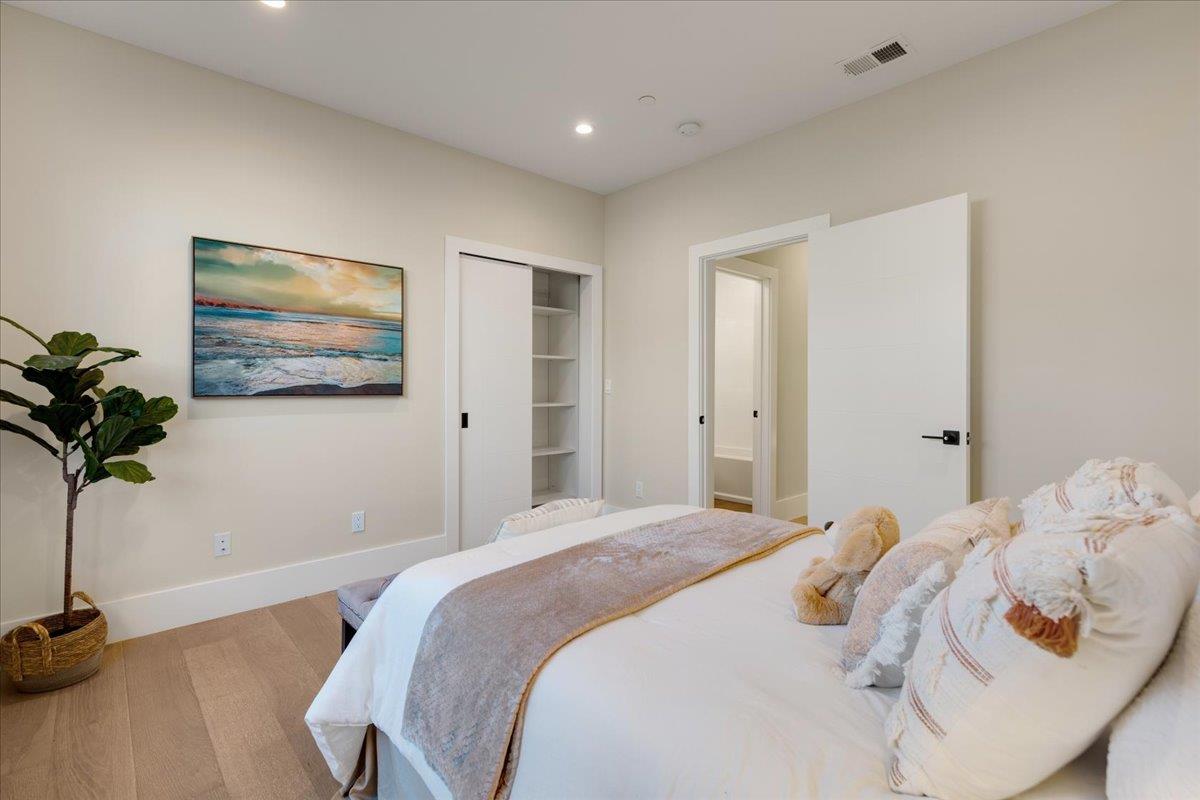 1472 South Wolfe Road Sunnyvale, CA 94087 - Photo 20 of 47 a bedroom with a bed and a painting on the wall