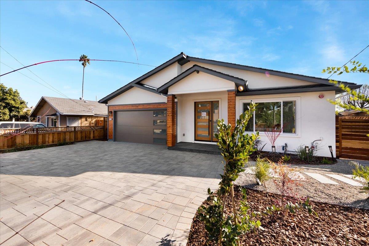 1472 South Wolfe Road Sunnyvale, CA 94087 - Photo 2 of 47 a view of a house with a yard and garage