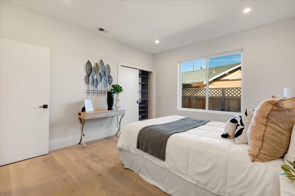 1472 South Wolfe Road Sunnyvale, CA 94087 - Photo 23 of 47 a bedroom with a bed and a painting on the wall