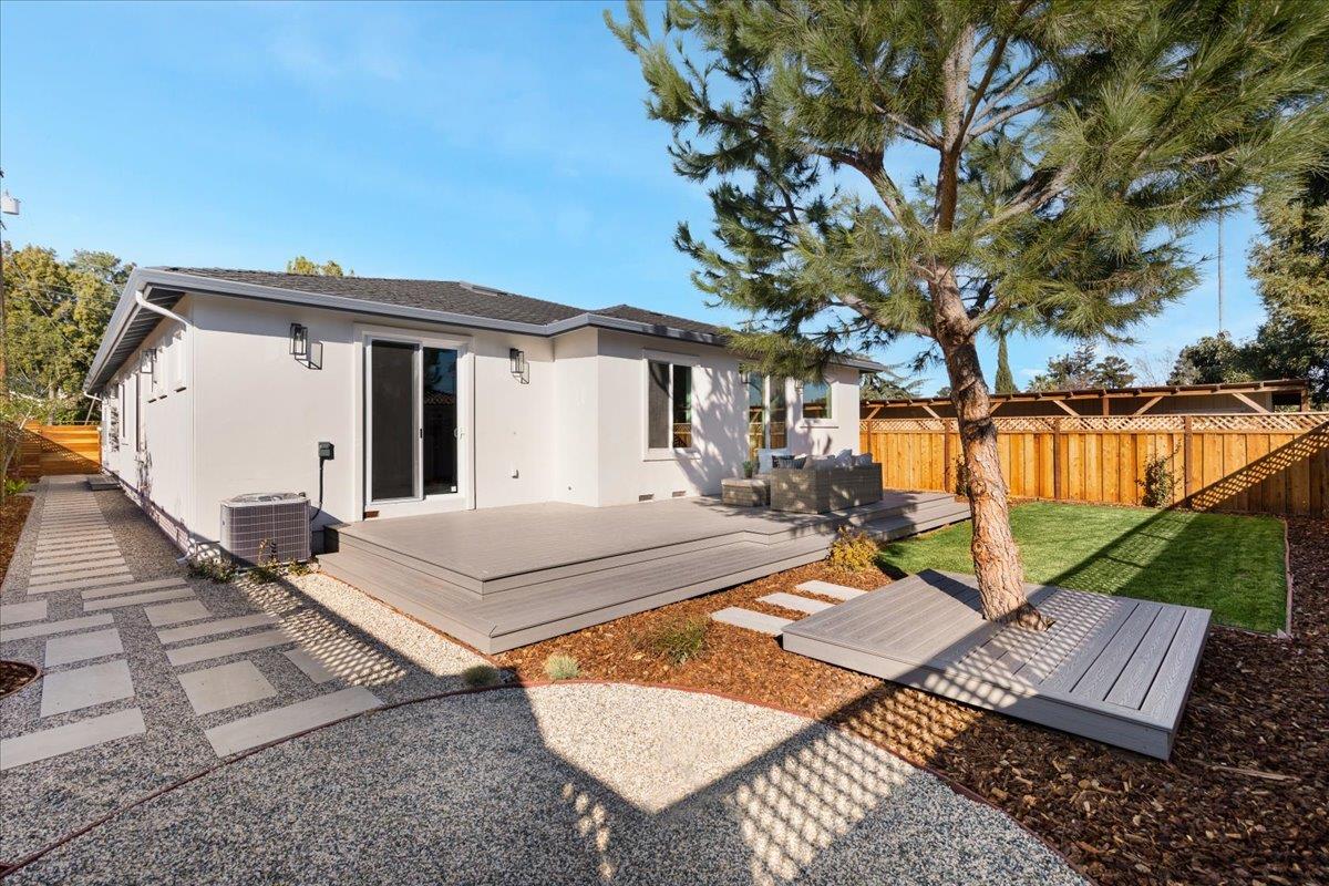 1472 South Wolfe Road Sunnyvale, CA 94087 - Photo 43 of 47 a view of a patio with table and chairs with wooden floor and fence