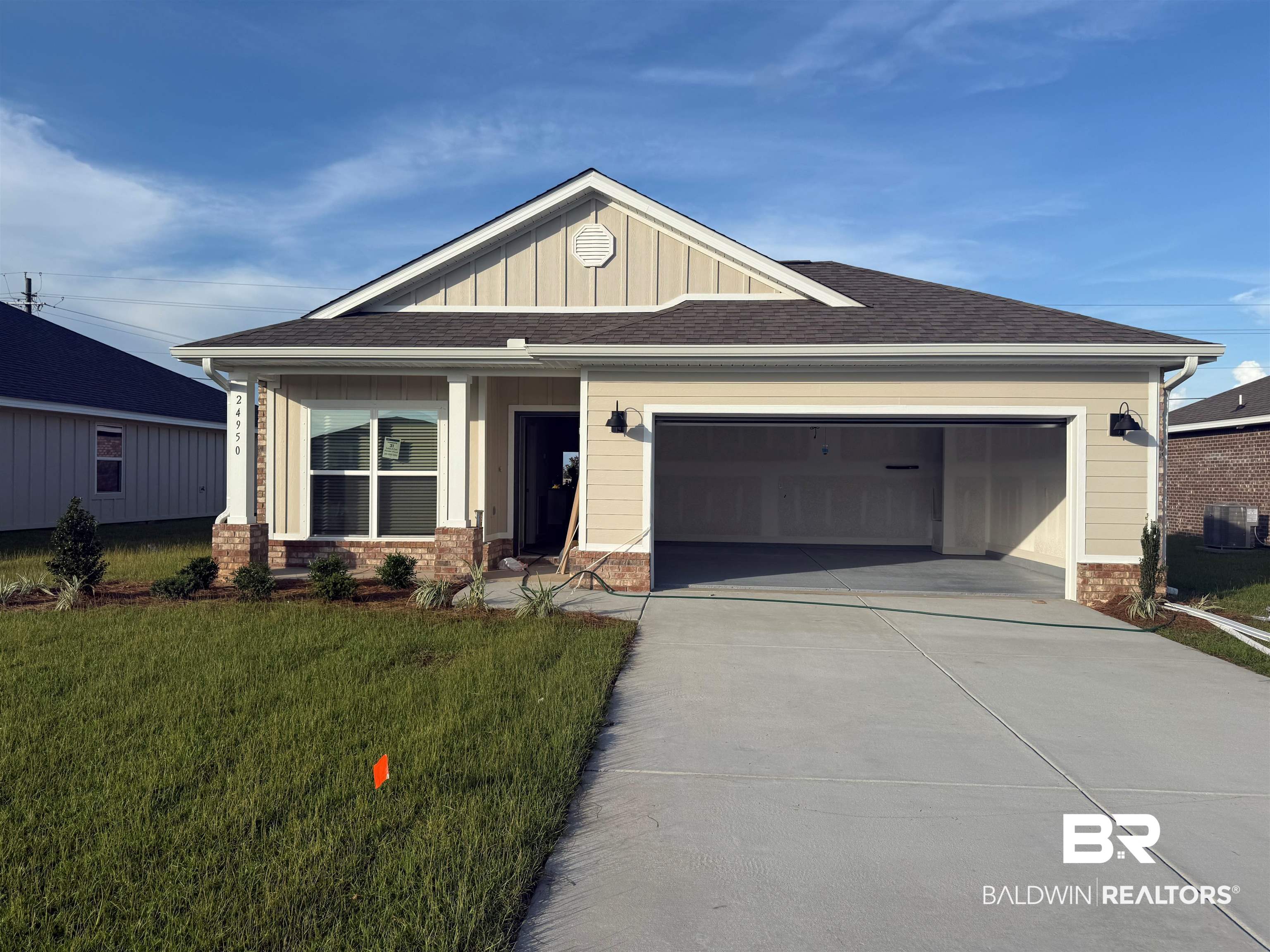24950 Ponder Loop Loxley, AL 36551 - Photo 2 of 45 Craftsman-style home with concrete driveway, an attached garage, a front lawn, brick siding, and board and batten siding