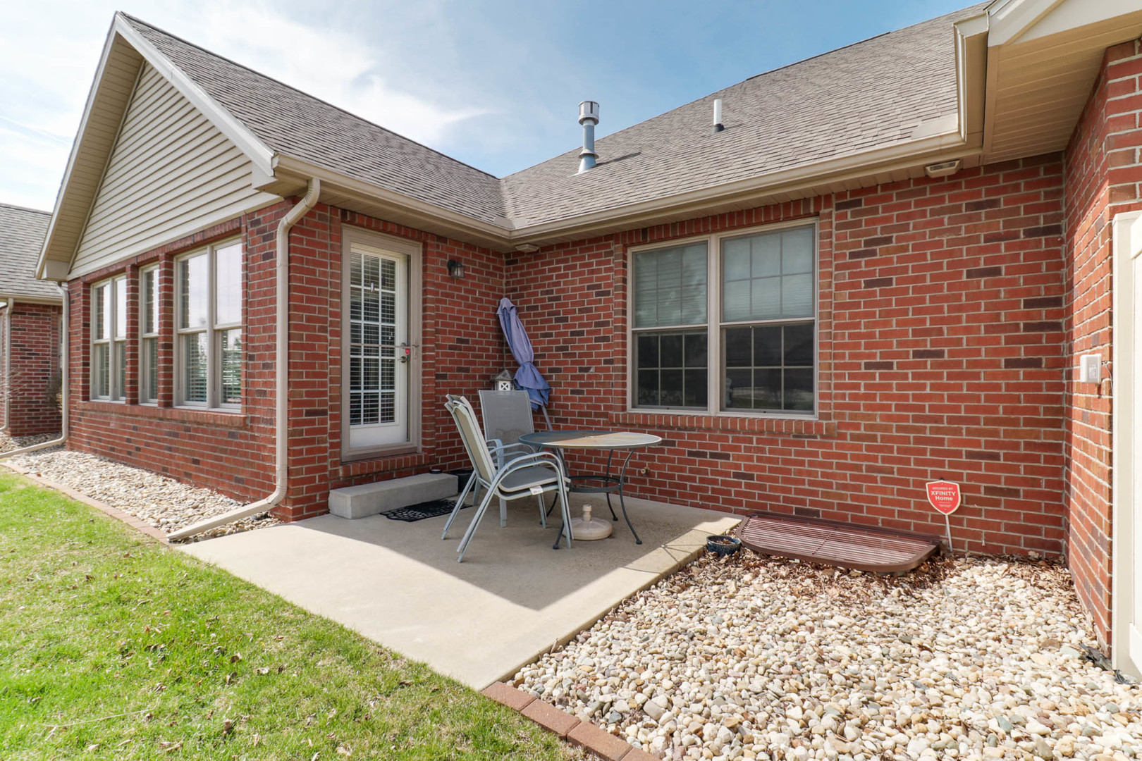 1770 Lockspur Way, Unit 1770 Normal, IL 61761 - Photo 35 of 39 a brick house with a large window and wooden fence