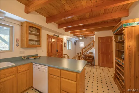 a kitchen with granite countertop a sink a stove and cabinets