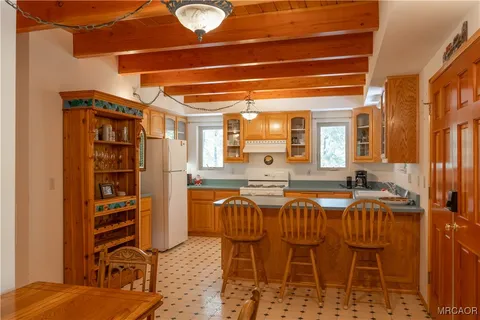 a dining table with chairs and cabinets