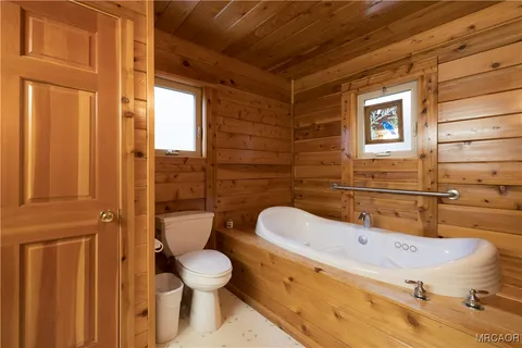 a bathroom with a toilet a sink and bathtub